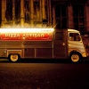 The Pizza Artisan van lit up on St Aldates after dark