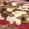 Pizza with mozzarella and black olives fresh from the oven